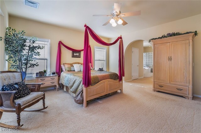 carpeted bedroom with multiple windows and ceiling fan