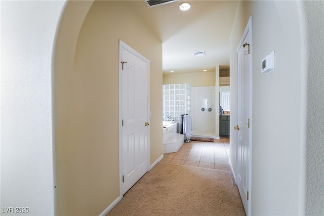 hallway with light carpet