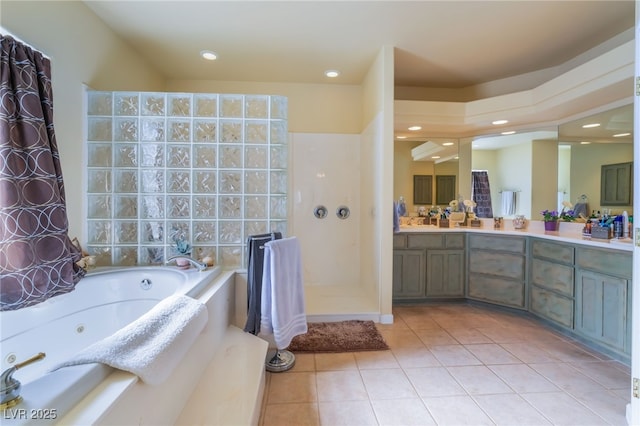 bathroom featuring tile patterned floors, a bath, and vanity