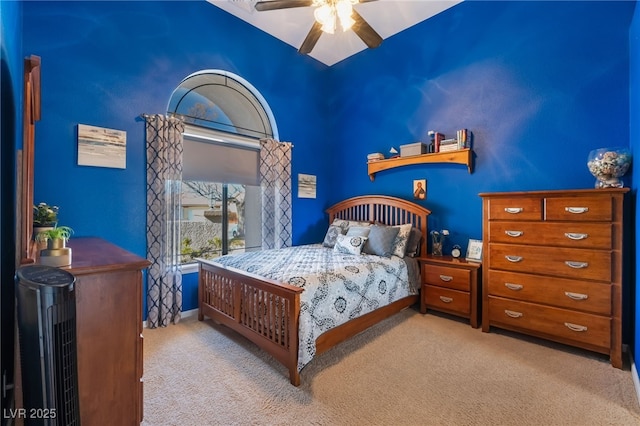 bedroom featuring light colored carpet and ceiling fan