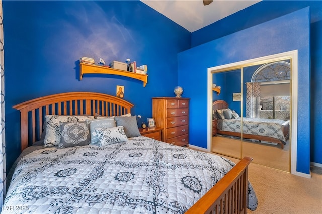 bedroom with a closet, ceiling fan, and carpet