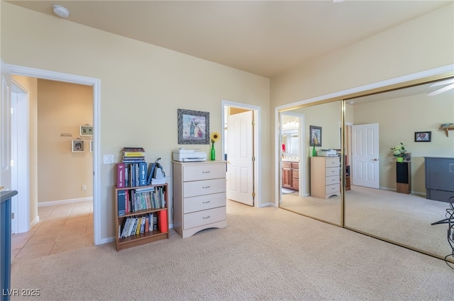 carpeted bedroom featuring a closet and ensuite bathroom