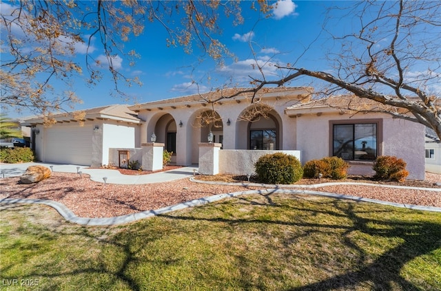 mediterranean / spanish-style home featuring a garage and a front yard