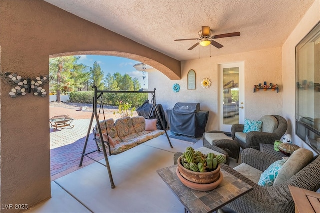 view of patio / terrace with an outdoor living space, ceiling fan, and grilling area