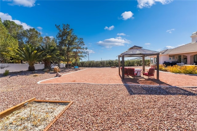 view of playground featuring a gazebo and a patio