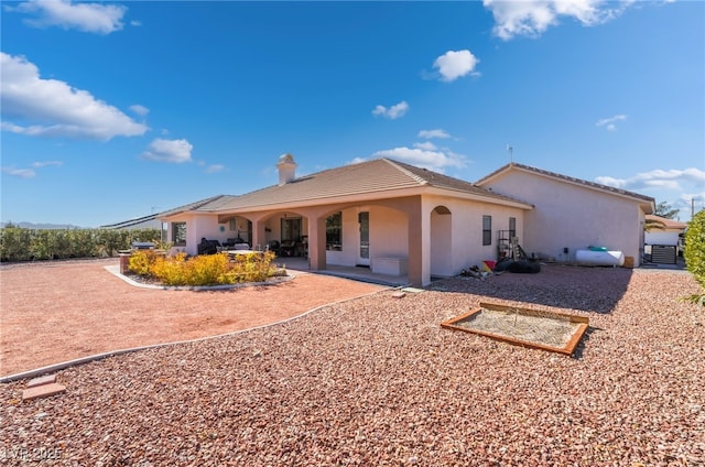 rear view of property featuring a patio