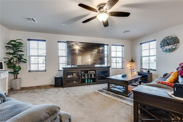 carpeted living room featuring ceiling fan