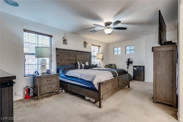 carpeted bedroom featuring stainless steel fridge and ceiling fan