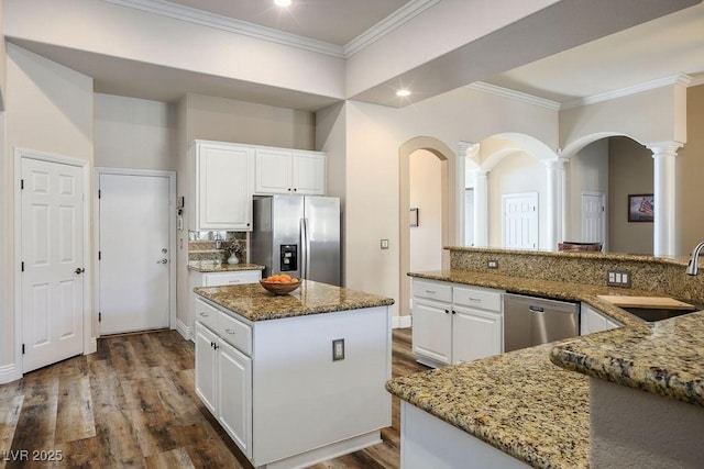 2012 Poetry Ave, Henderson, NV 89052 - kitchen with ornamental molding, appliances with stainless steel finishes, white cabinets, stone countertops, and a sink