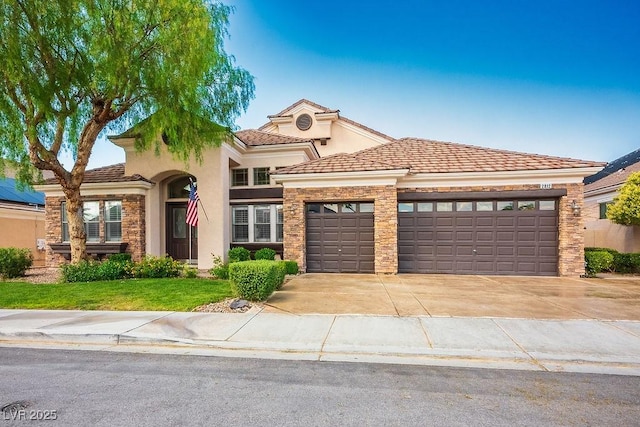 mediterranean / spanish-style home with a front yard, stucco siding, a garage, stone siding, and driveway