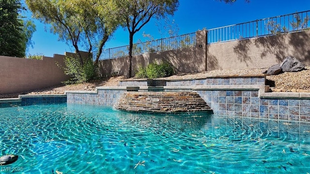 view of swimming pool with a fenced backyard and a fenced in pool