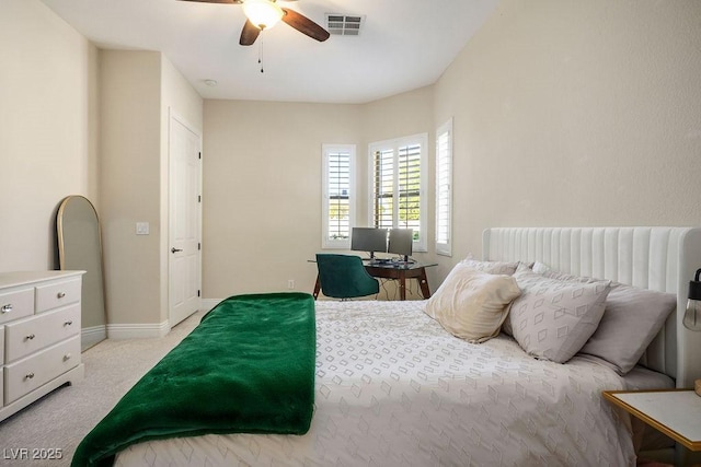 bedroom with light carpet, baseboards, visible vents, and a ceiling fan