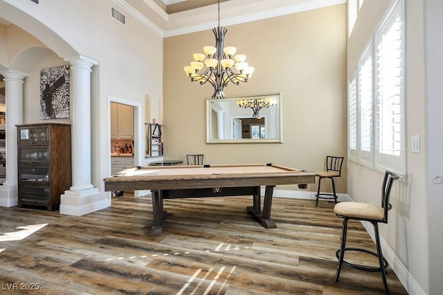 playroom with arched walkways, pool table, wood finished floors, and ornate columns