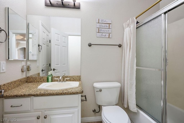 full bathroom featuring shower / bath combination with glass door, vanity, and toilet