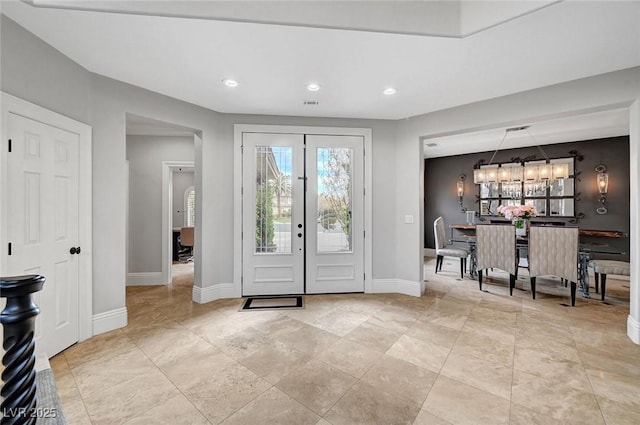 entryway with a notable chandelier and french doors