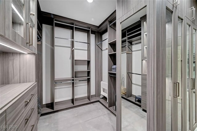 spacious closet with light tile patterned floors