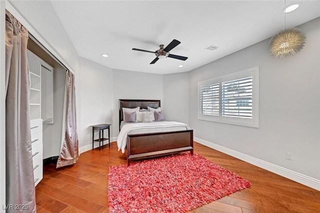 bedroom with wood-type flooring and ceiling fan