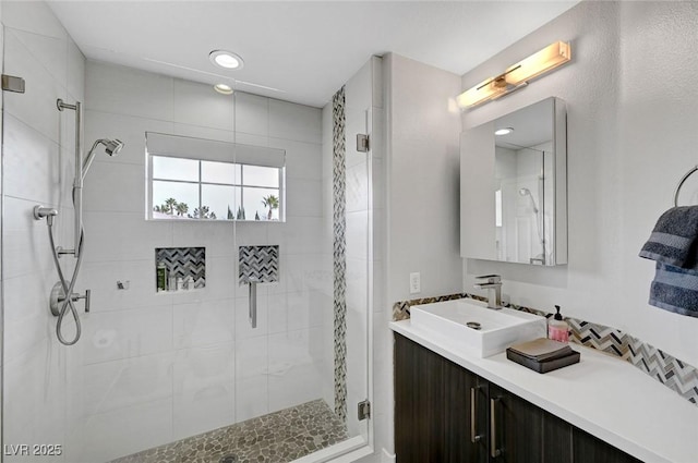 bathroom featuring vanity and an enclosed shower