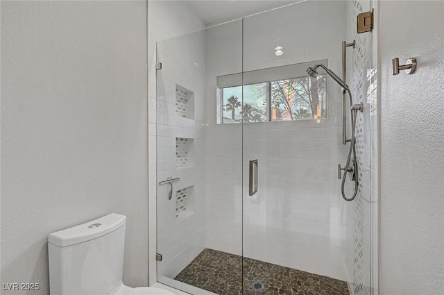 bathroom featuring an enclosed shower, mail boxes, and toilet