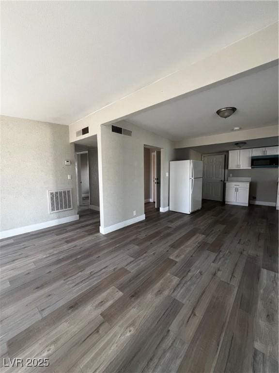 unfurnished living room featuring dark wood-type flooring