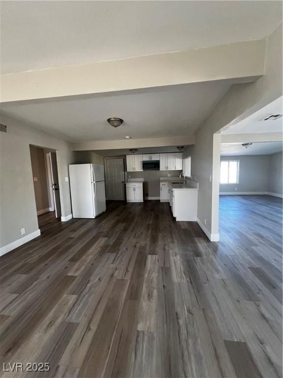 unfurnished living room with dark hardwood / wood-style flooring