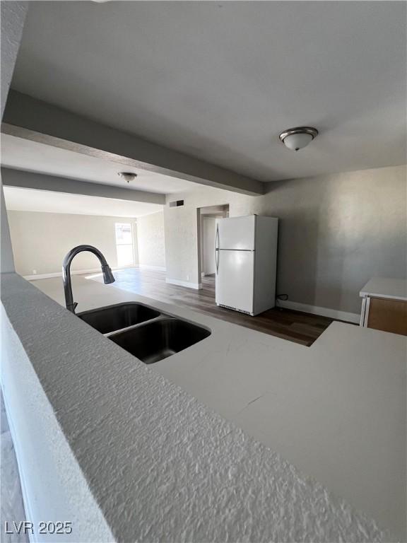 kitchen with sink and white fridge