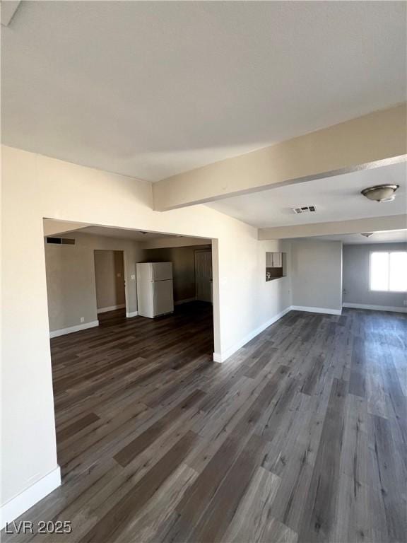 unfurnished living room featuring dark hardwood / wood-style floors