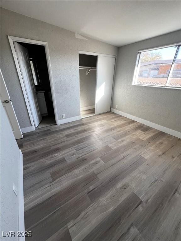 unfurnished bedroom featuring hardwood / wood-style floors and a closet