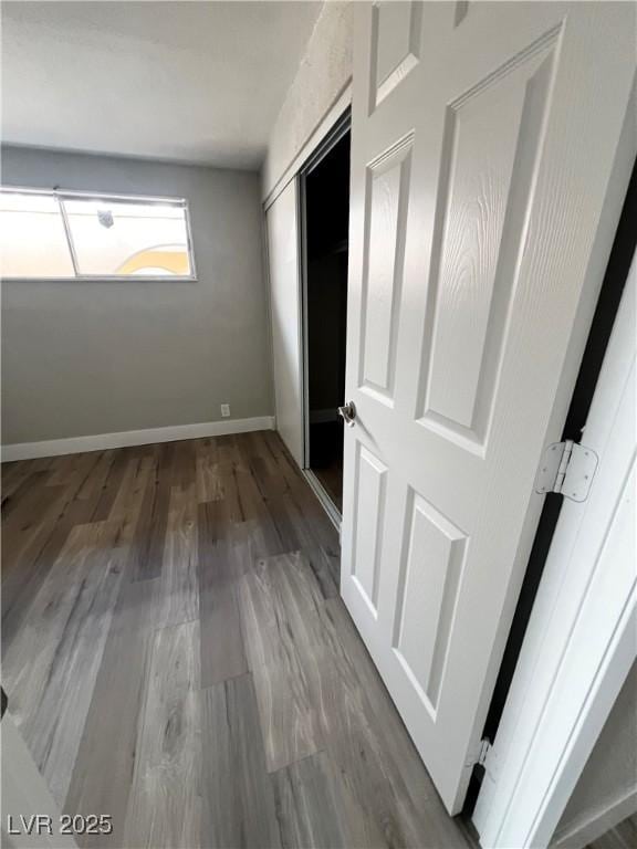 unfurnished bedroom with hardwood / wood-style floors and a closet