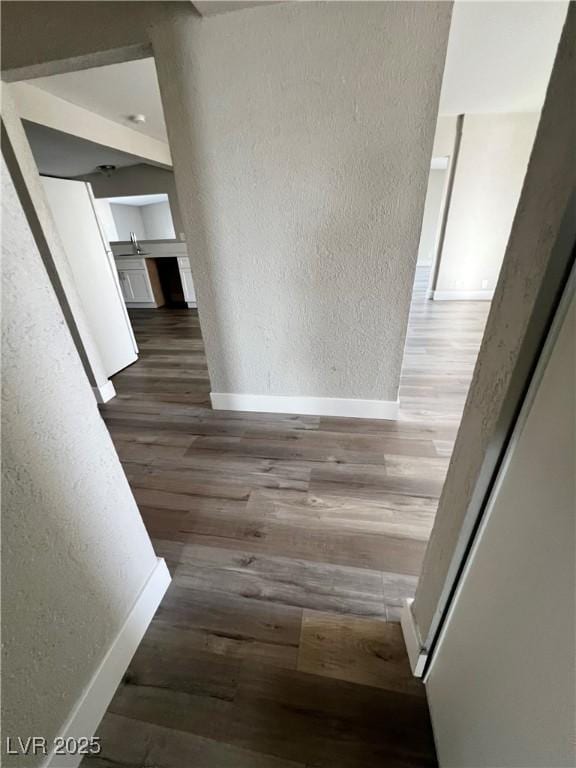 corridor featuring dark hardwood / wood-style flooring