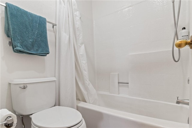 bathroom with toilet and shower / bath combo with shower curtain