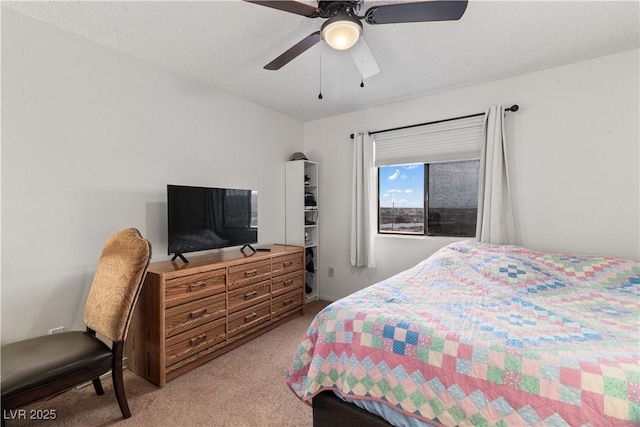 bedroom featuring light colored carpet, a textured ceiling, and ceiling fan