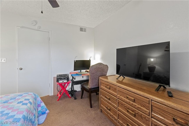 bedroom featuring ceiling fan, carpet floors, and a textured ceiling