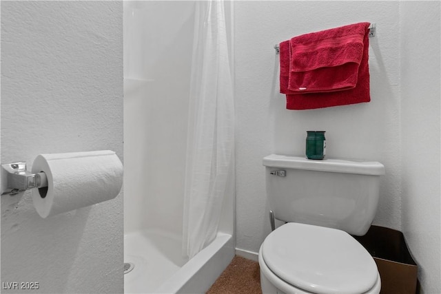 bathroom with a shower with curtain and toilet