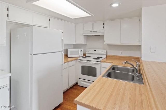 kitchen featuring light wood-type flooring, white appliances, sink, and white cabinets