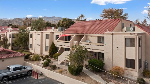 view of building exterior featuring a mountain view and central AC unit