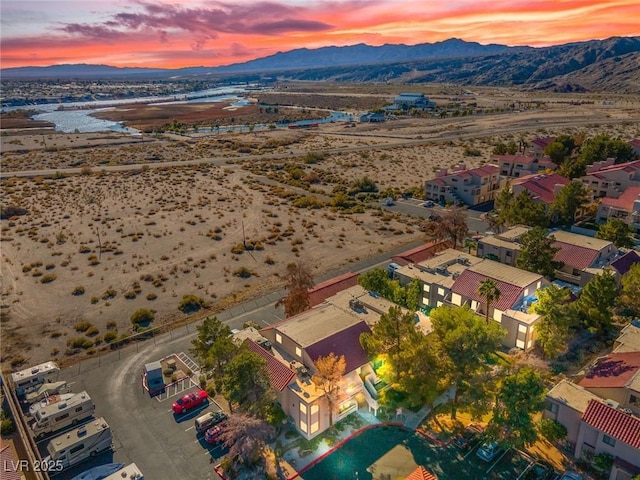 aerial view at dusk featuring a mountain view