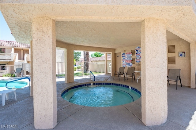 view of swimming pool with a community hot tub and a patio area