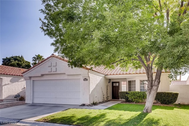 mediterranean / spanish-style house featuring a garage and a front lawn