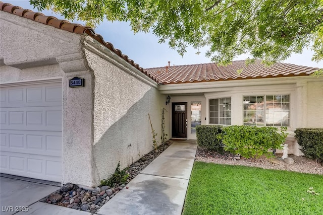 view of exterior entry with a garage