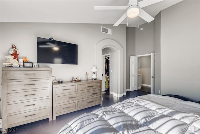 bedroom featuring vaulted ceiling, dark hardwood / wood-style floors, ceiling fan, and a closet