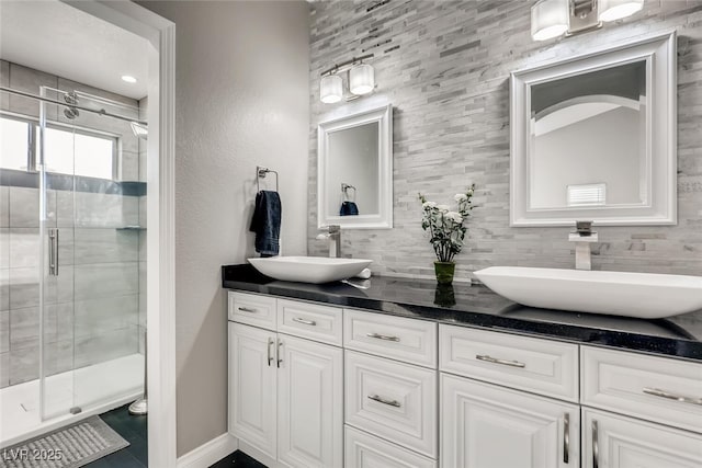 bathroom with tasteful backsplash, vanity, and an enclosed shower