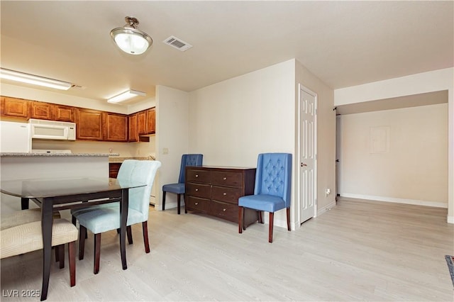 dining room featuring light hardwood / wood-style floors