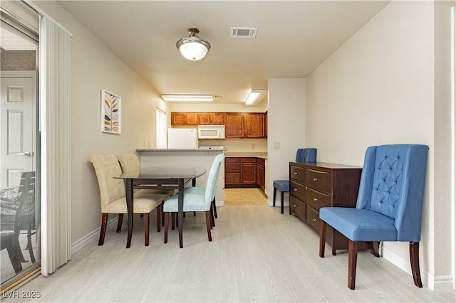 dining space featuring light hardwood / wood-style flooring