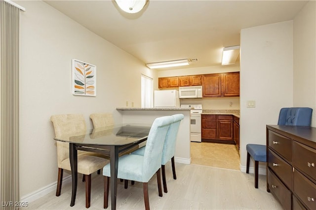 dining space featuring light hardwood / wood-style floors