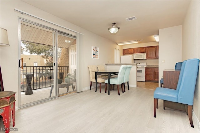 dining area with light hardwood / wood-style floors