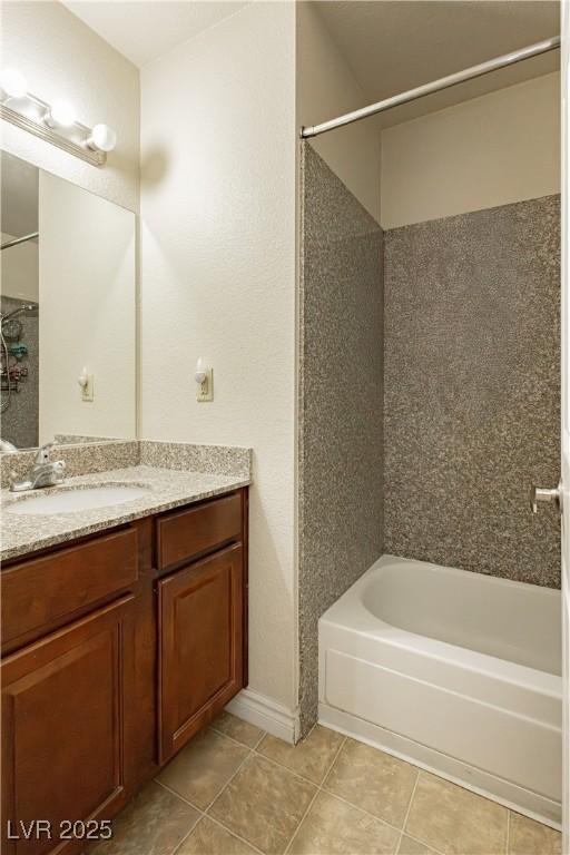 bathroom featuring vanity, tub / shower combination, and tile patterned floors