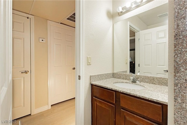 bathroom featuring vanity and hardwood / wood-style floors