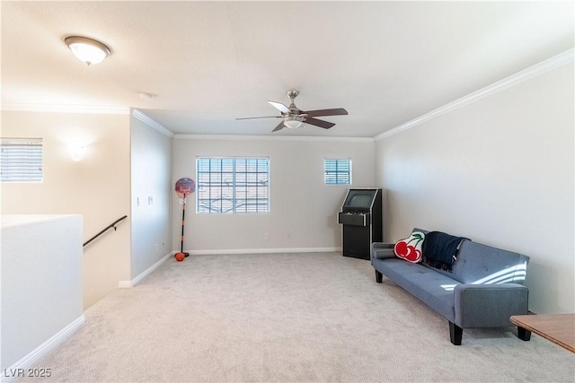 sitting room with ceiling fan, ornamental molding, and light carpet