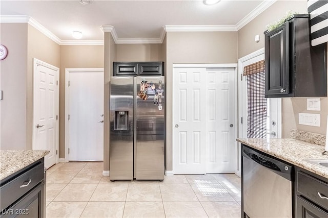 kitchen with light tile patterned flooring, ornamental molding, appliances with stainless steel finishes, and light stone countertops